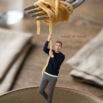 Cinematic Macro Micro Scene Tiny Man Hanging From Noodles Fork Lift - Free Ai Prompt